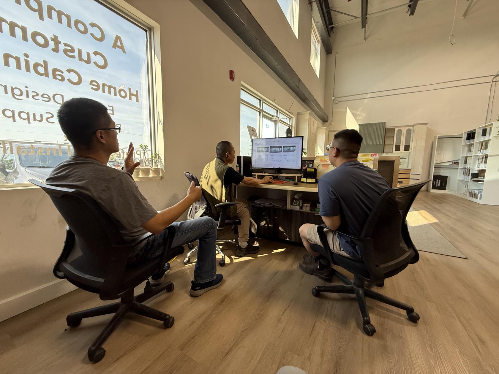 Gordon, Vincent, and Ron reviewing design plans at Ron's showroom